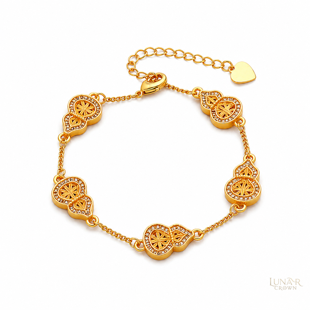 Gold-tone hulu gourd bracelet with five openwork motifs and adjustable extension chain on a white background