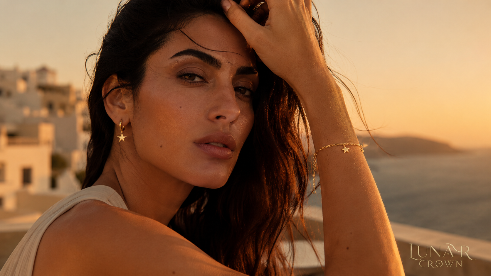 Model wearing a gold-tone star earring at sunset
